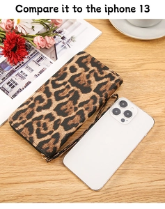 Leopard print long wallet with gold zipper compared to an iPhone 13 for size reference