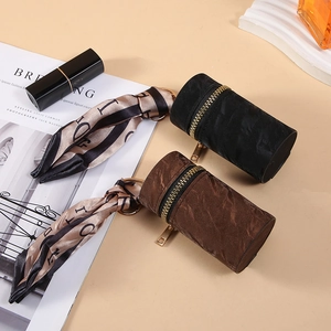 Fashionable cylindrical mini coin purse with decorative silk scarf and gold zipper closure