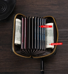 Internal view showing multiple card slots and banknote slots of the black leather wallet