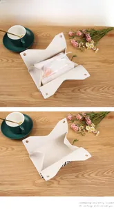 Detail of white PU leather tissue box showing foldable snap design and internal storage space