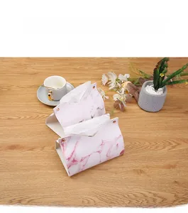 Detail of marble pattern faux leather tissue box with elegant metal snap fasteners