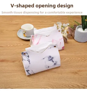 Detail of marble pattern leather tissue box with V-shaped opening and gold metal studs