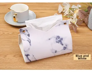 Detail of blue and white marble pattern on the PU leather tissue box with gold buttons