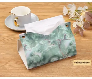 Close-up of yellow-green marble pattern leather tissue box with gold metal buckles
