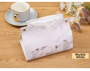 Detail of yellowish white marble pattern leather tissue box with gold metal buckles