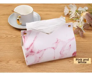 Close-up of pink and white marble pattern PU leather tissue box with gold buttons