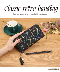 Detail of long black PU wallet with geometric patterns, wrist strap and heart tassel