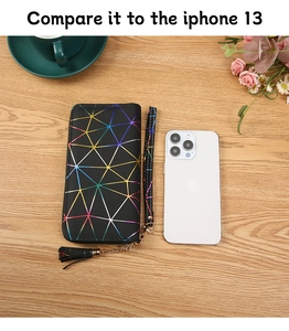 Geometric pattern long wallet size comparison with iPhone 13 on a wooden table
