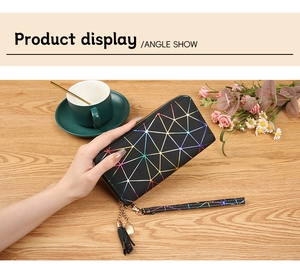 Close-up of geometric pattern wallet with heart charm, tassel, and wrist strap