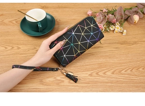 Macro shot of geometric laser holographic pattern on long wallet with heart charm