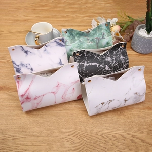 Modern marble texture PU leather tissue boxes in various colors on a wooden table