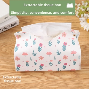 Detail of white PU leather tissue box with floral patterns and gold metal buckles