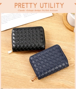 Detailed view of woven leather texture on zip wallets in black and navy colors