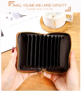 Detailed view of brown woven card holder with accordion slots and gold zipper closure