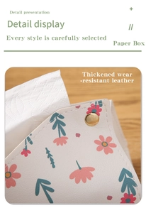 Detail of cream leather tissue box with floral pattern and gold metal snap closure