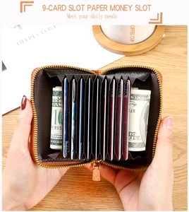 Macro detail of the brown leather accordion card holder with multiple slots and gold zipper