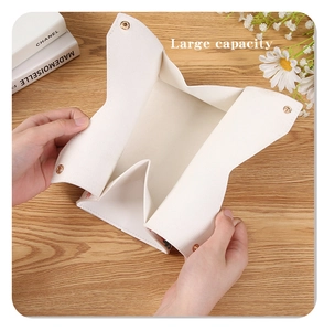 Close-up of white lychee texture leather tissue box with a secure gold metal buckle