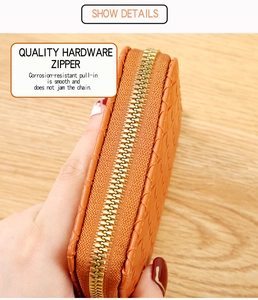 Detail of orange woven wallet showing smooth anti-corrosion gold metal zipper