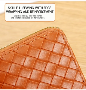 Macro detail of brown woven leather wallet with fine stitching and durable metal zipper