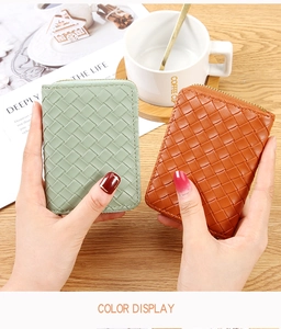 Detail of woven leather card holders in light green and caramel with gold zippers
