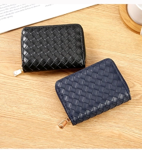 Close-up of woven texture detail on black and navy leather card holder wallets