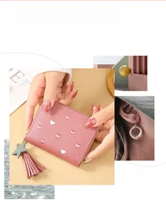 Pink lychee grain leather wallet with heart embroidery, tassel, and star charm detail
