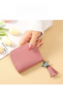 Detailed shot of Morandi pink small wallet with metal zipper and fringe star tassel charm