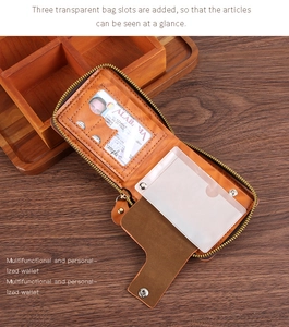 Detail of vintage brown PU wallet showing three transparent card slots on wood background