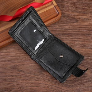 Men's vintage black bifold wallet with coin pocket and ID window on dark wood background