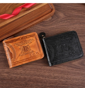 Top view of vintage US dollar pattern wallets in black and brown on a wooden desk