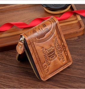 Detail of vintage embossed $100 bill pattern on caramel PU leather wallet on wooden table
