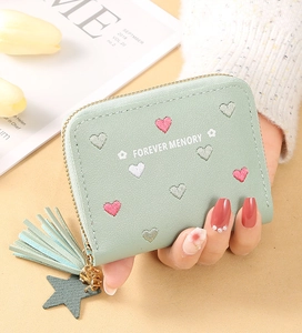Detail of mint green PU leather wallet with heart embroidery and tassel star charm