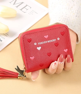 Detail of red PU leather wallet with heart embroidery, zipper, and tassel charm