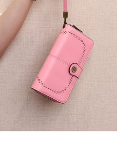 Detailed view of pink long wallet featuring hollow lace edges and sunflower metal buckle