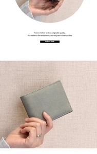 Close-up of grey Oxford cloth texture and neat stitching on a durable men's wallet