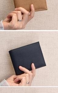 Detail of hand-held canvas bifold wallets in khaki and navy with precise stitching