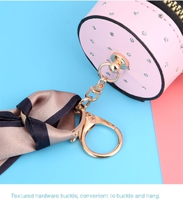 Detail of pink quilted leather mini pouch with silk scarf and gold lobster clasp