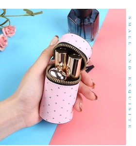 Pink rhinestone quilted mini bucket bag showing storage for three lipsticks
