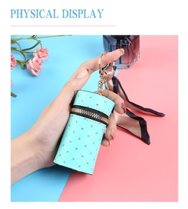 Detail view of mint green mini cylinder bag with diamond pattern and silk ribbon