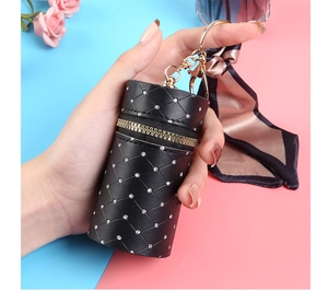 Detail of black quilted bucket mini pouch with rhinestones and silk scarf keychain