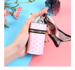 Detailed view of a pink quilted leather mini pouch with rhinestones and silk scarf