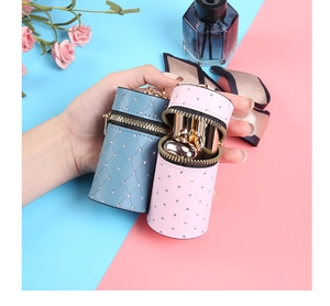 Detailed view of quilted leather lipstick pouches with rhinestones and gold hooks