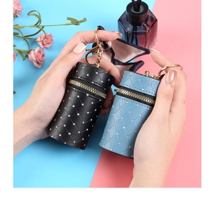 Detailed view of mini quilted leather lipstick pouch charms with diamond accents