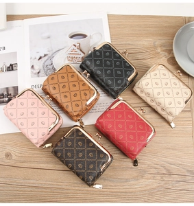 Flat lay of small heart print coin purses in six colors with metal clasp on wooden background