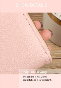 Detail of pink lychee grain leather with neat stitching and smooth zipper edge