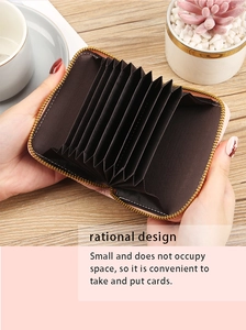 Detailed macro view of pink PU leather accordion card holder with golden zipper closure