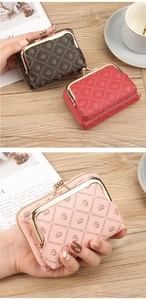 Detail of lychee pattern leather wallet with heart print and vintage metal kiss-lock