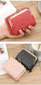 Detail view of colorful pebbled leather wallets with elegant metal clasp and heart print
