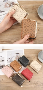 Detailed view of small faux leather coin purse with heart print and metal clasp closure