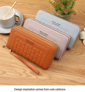 Detail of long double-zipper wallets with quilted wave texture and leather wrist straps